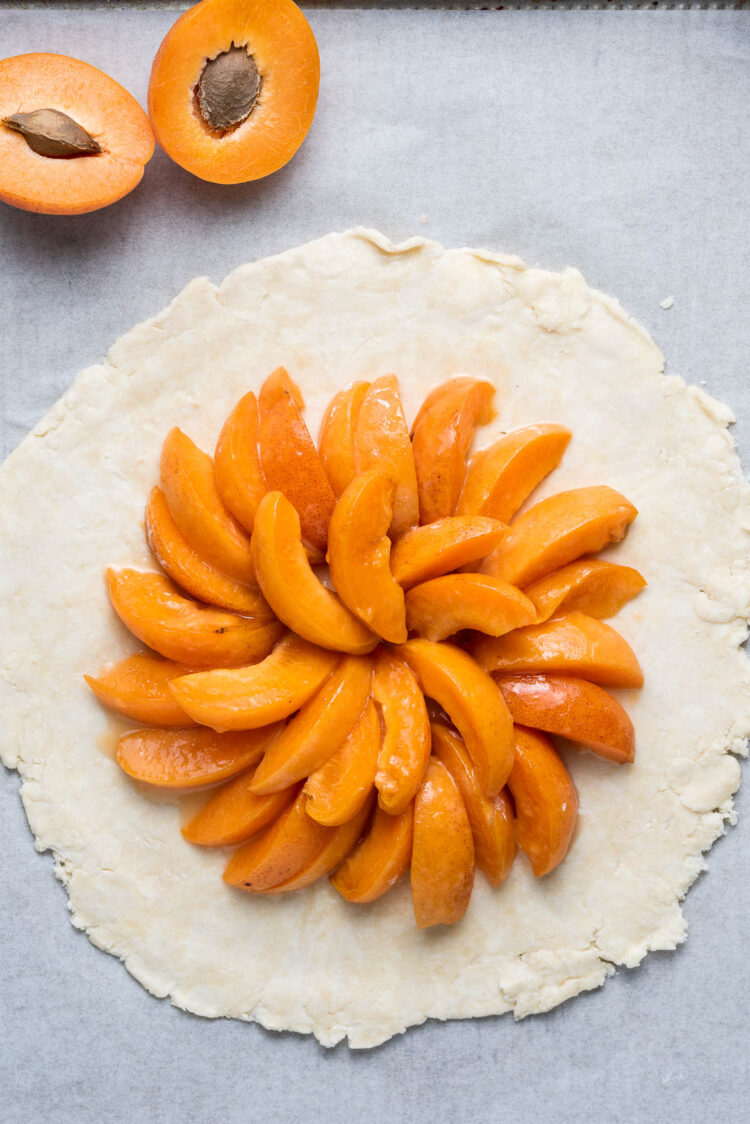 Arranging apricots in galette dough.