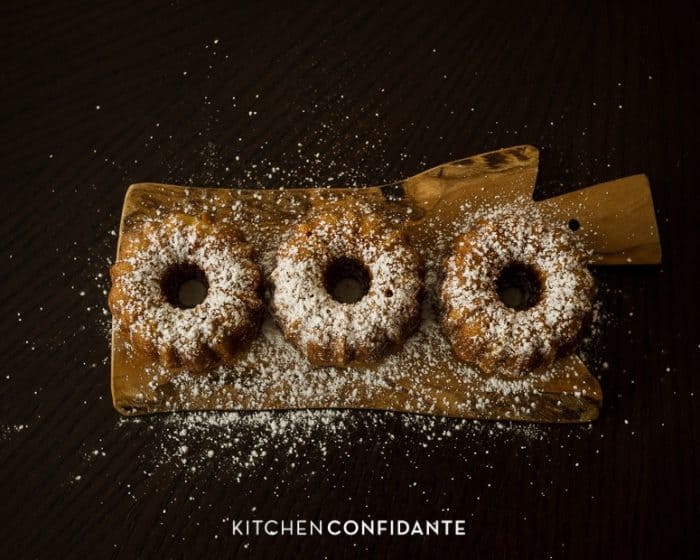 Mini cakes dusted with powdered sugar.