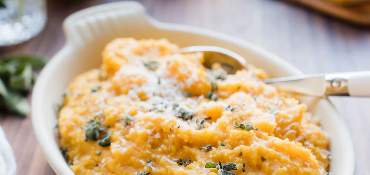 A white serving bowl filled with Pumpkin Sage Polenta.