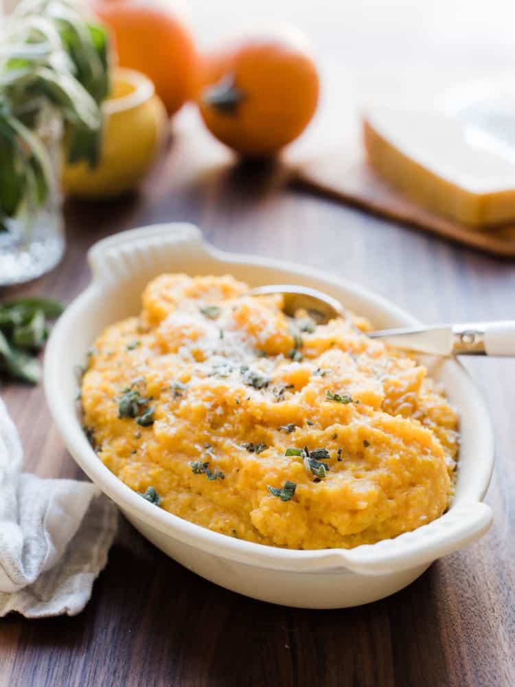 A white serving bowl filled with Pumpkin Sage Polenta.