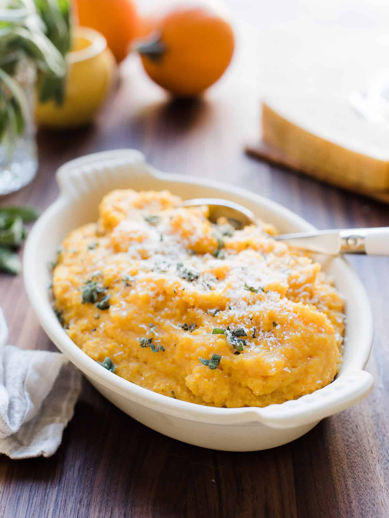 A white serving bowl filled with Pumpkin Sage Polenta.