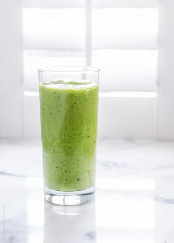 Mango Spinach Green Smoothie against a white background