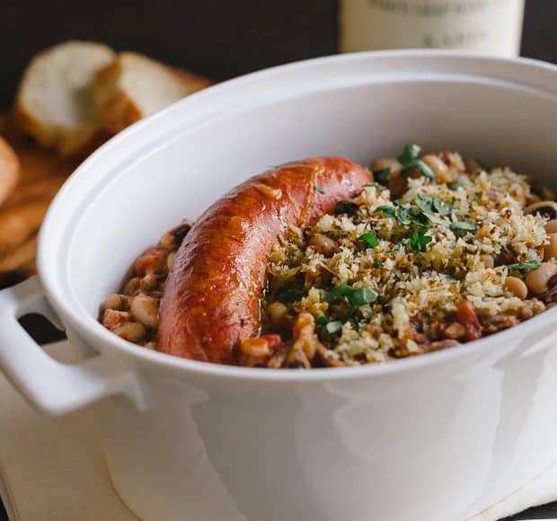 Black Eyed Pea Cassoulet with sausage in a serving dish.