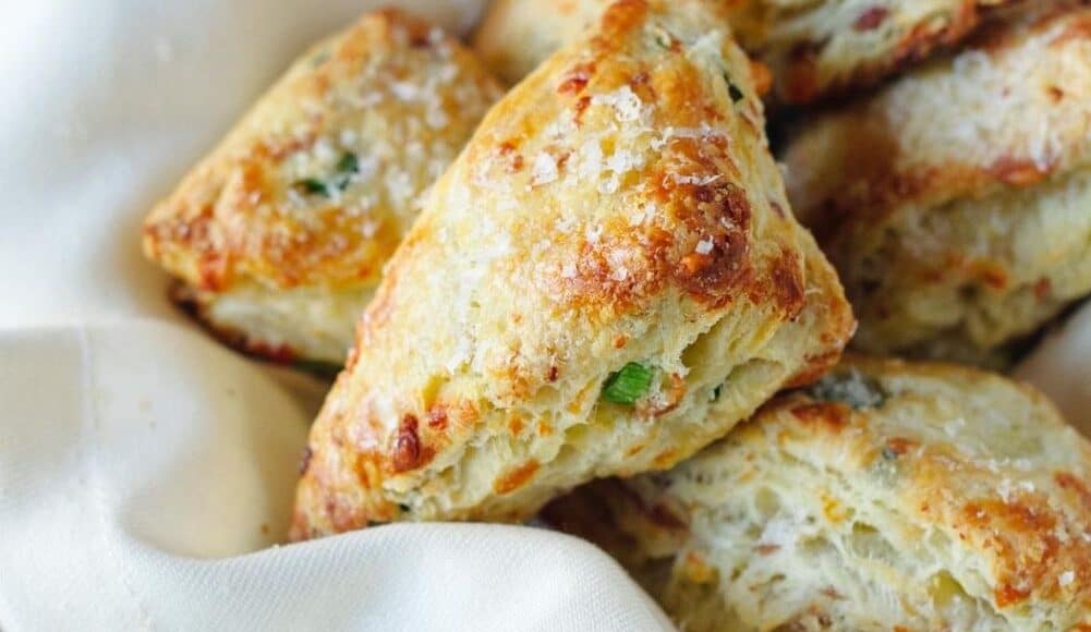 Savory Scones with Gruyere, Prosciutto and Green Onion in a basket with a white napkin