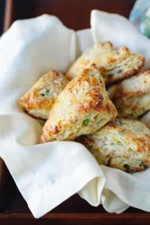 Savory Scones with Gruyere, Prosciutto and Green Onion in a basket with a white napkin