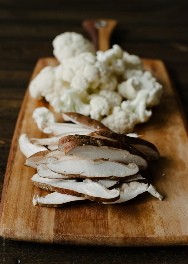 Sliced mushrooms on wooden board. 