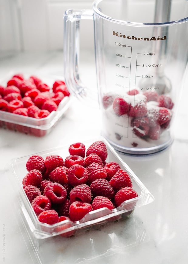 Fresh raspberries on a white surface. 