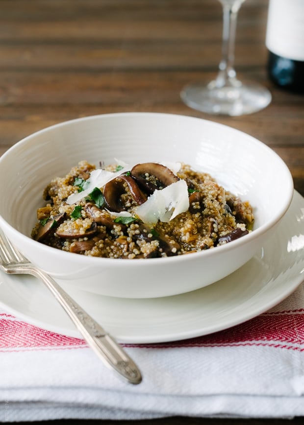 A bowl of healthy quinoa risotto topped with Parmesan shavings.