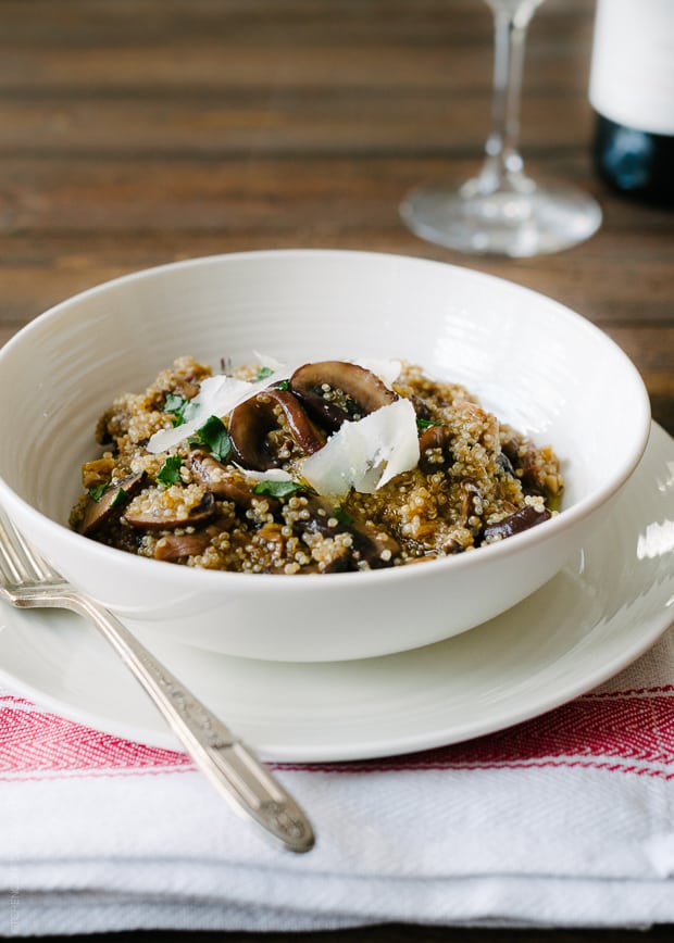 A bowl of healthy quinoa risotto topped with Parmesan shavings.