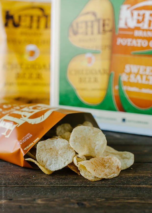 An opened bag of potato chips on a wooden surface.