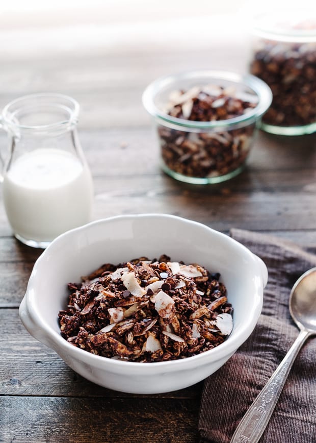 A bowl of Mocha Coconut Granola on a wooden surface.