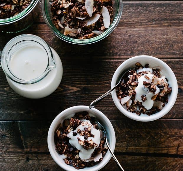 Small white bowls of Mocha Coconut Granola on a wooden surface.