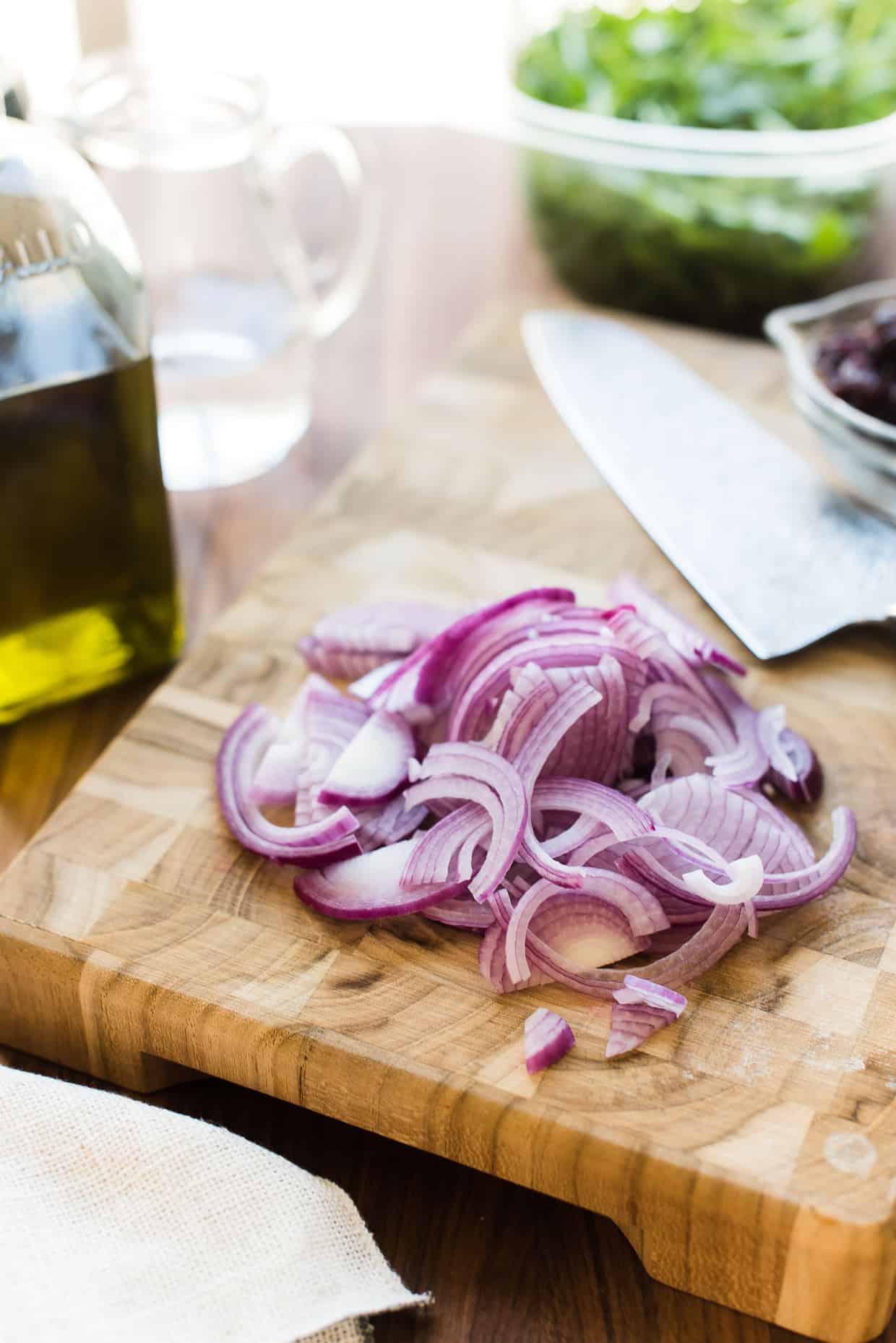 Sliced red onions for  Caramelized Onion, Feta and Serrano Ham Flatbread 