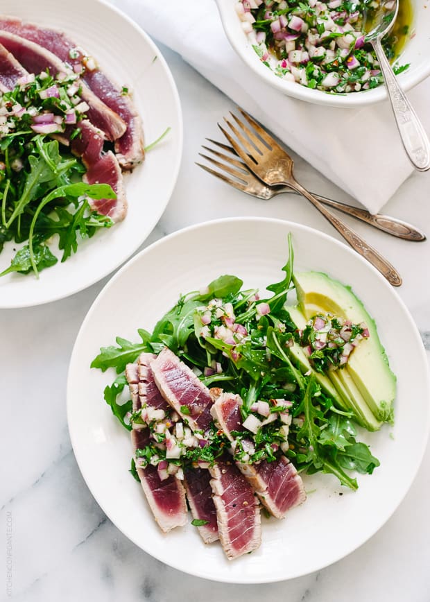 Seared Ahi Tuna with Chimichurri Sauce on a white plate.