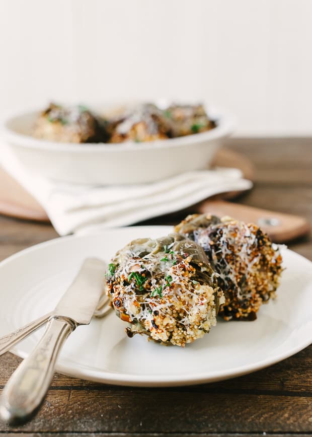 Cheesy Toasted Quinoa Stuffed Artichokes on a plate.