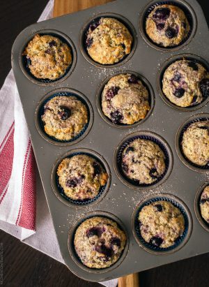 A muffin tin filled with Berry Flaxseed Muffins.