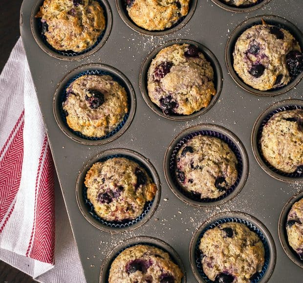 A muffin tin filled with Berry Flaxseed Muffins.