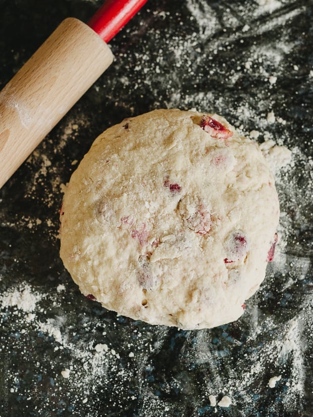 Cherry scone dough with a rolling pin nearby.