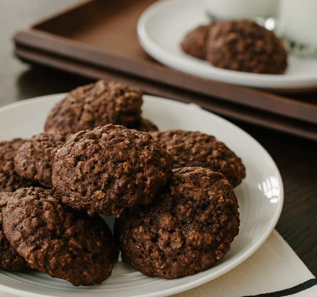 A white plate filled with chocolate oatmeal cookies.