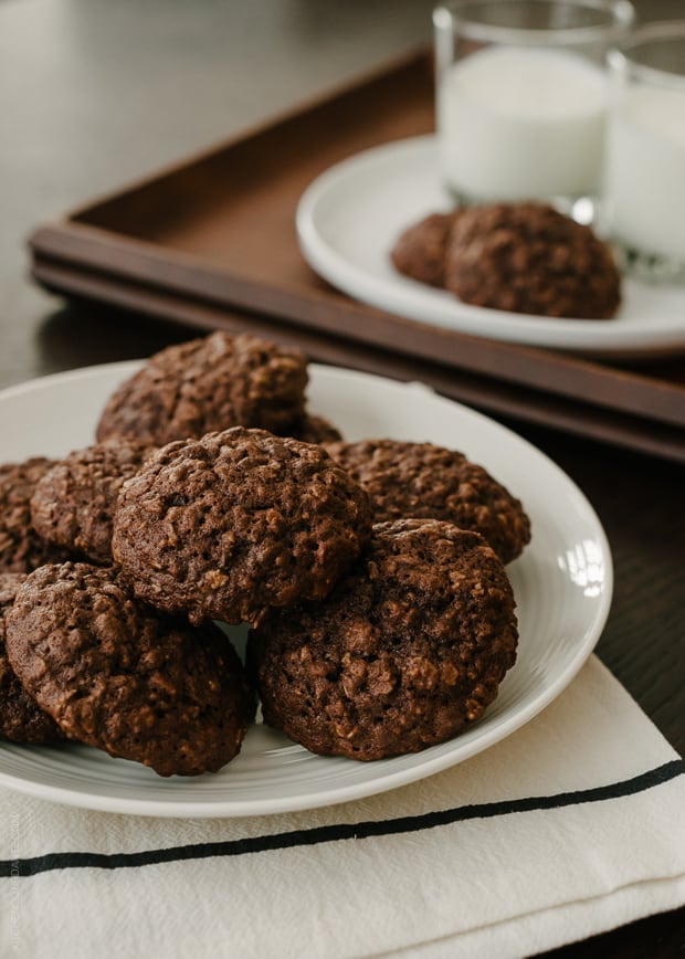 A white plate filled with chocolate oatmeal cookies.