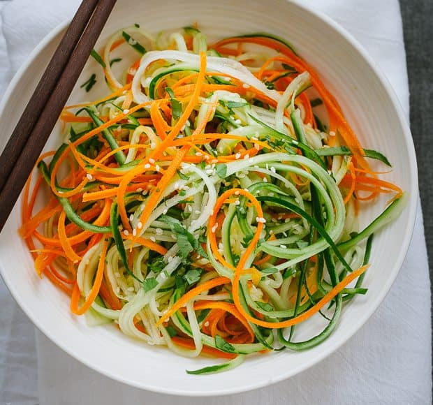 A white bowl filled with Asian Cucumber Carrot Slaw.