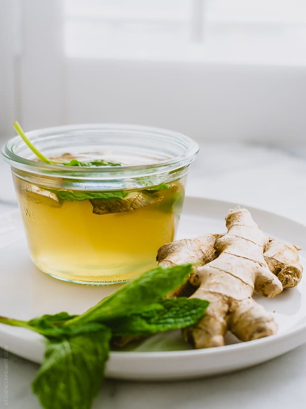 A coconut water cooler alongside fresh ginger.