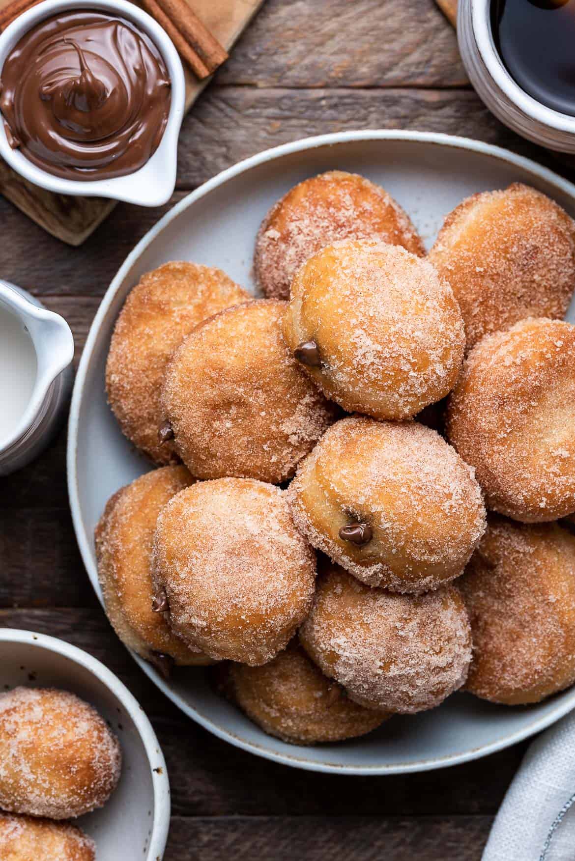 Nutella Filled Mini Doughnuts piled on a grey plate, overhead view