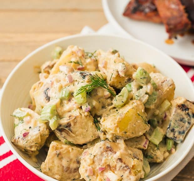 A white bowl full of Buffalo Ranch Grilled Potato Salad.