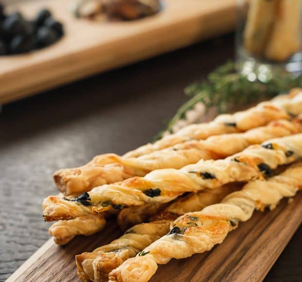 Olive Cheese Straws arranged on a serving board.