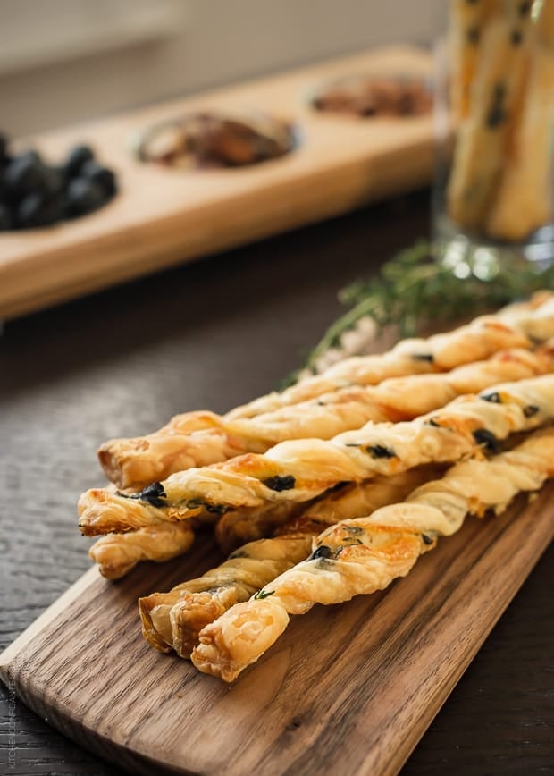 Olive Cheese Straws arranged on a serving board.