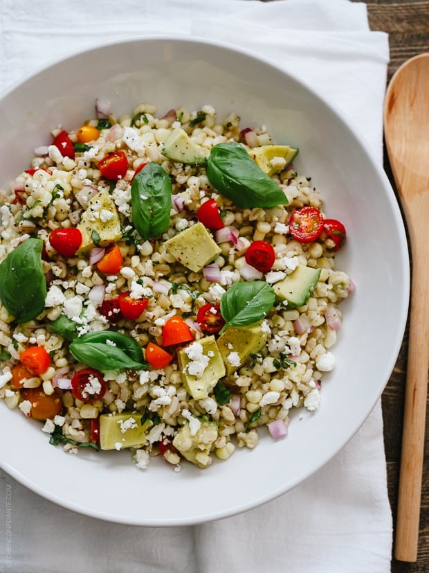 A large white bowl with Summer Corn and Barley Salad
