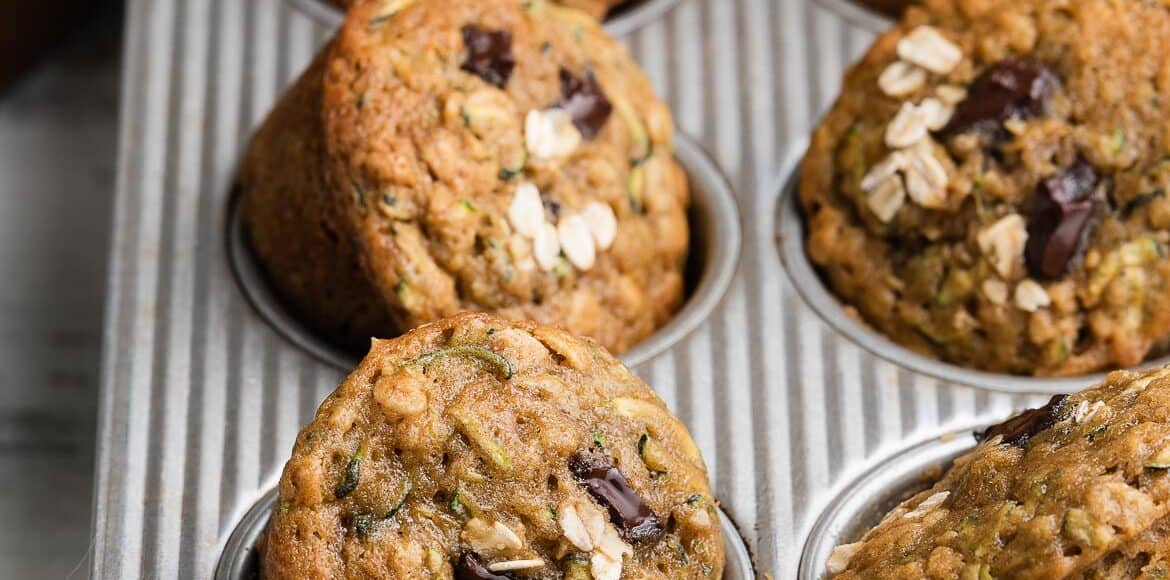 Zucchini Oat Chocolate Chunk Muffins in a muffin pan.