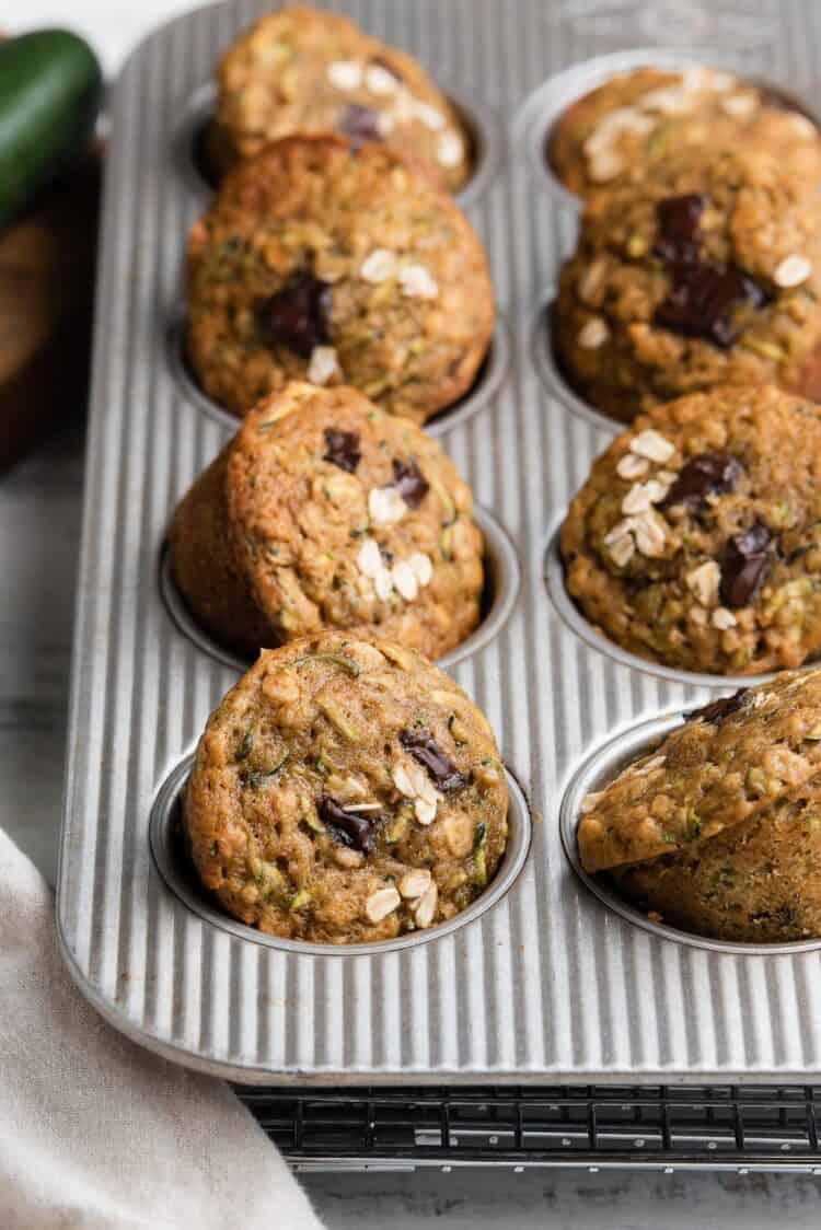 Zucchini Oat Chocolate Chunk Muffins in a muffin pan.