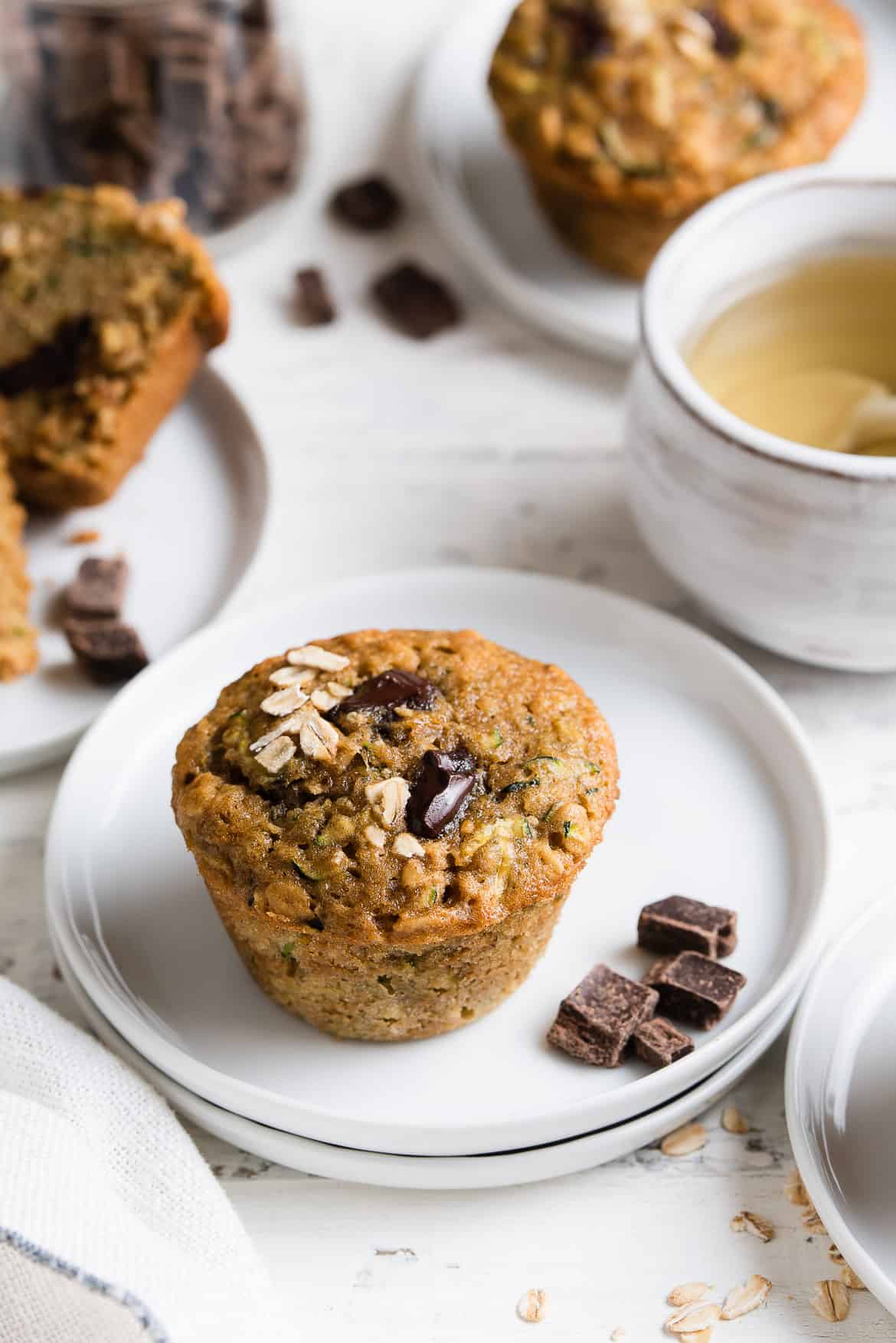 Zucchini Oat Chocolate Chunk Muffins on a small white muffin.