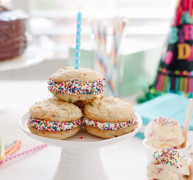 Birthday Cake Sandwich Cookies arranged on a small cake stand.