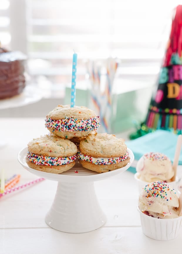 Birthday Cake Sandwich Cookies arranged on a small cake stand.