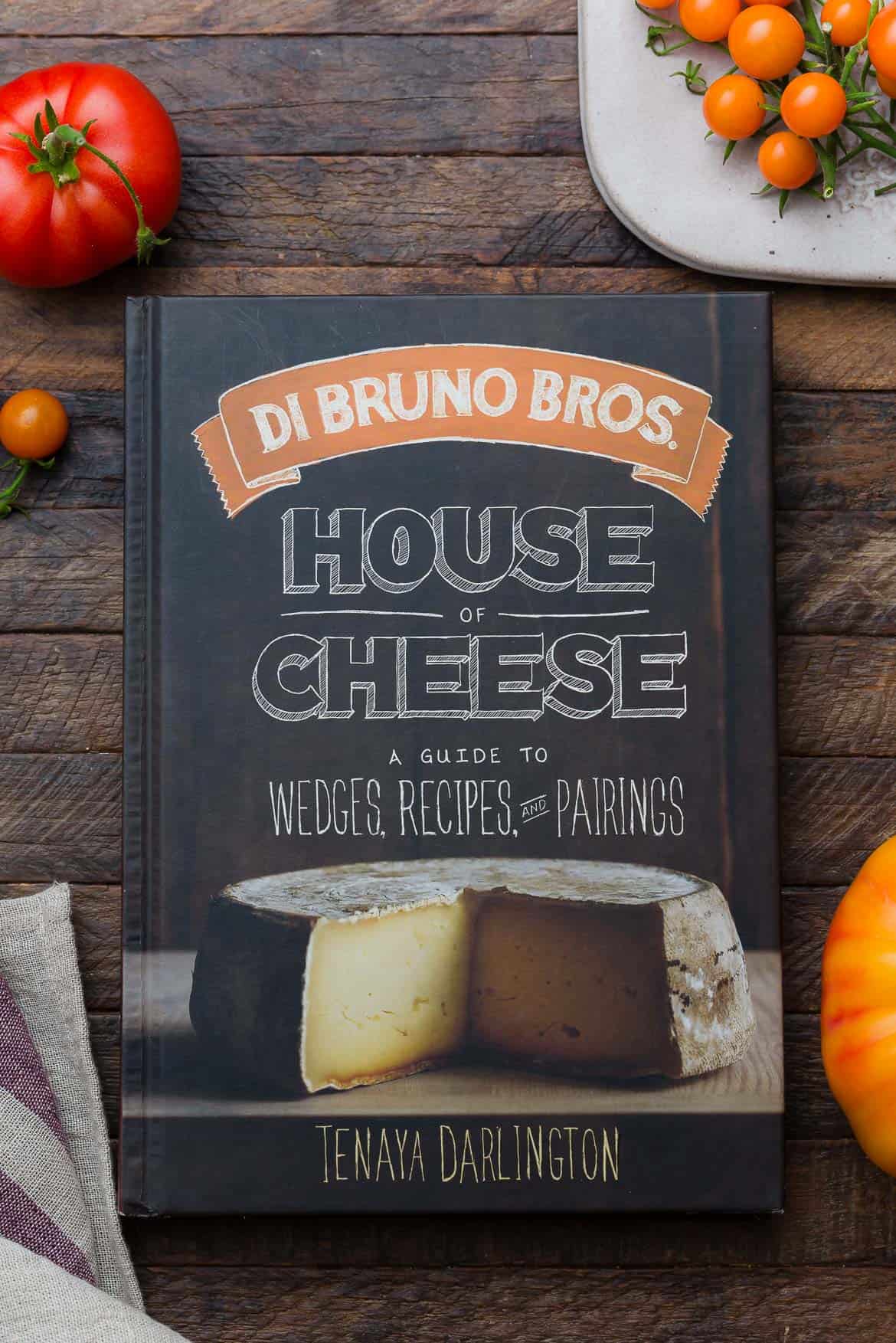 Di Bruno Bros House of Cheese Cookbook on a wooden surface.