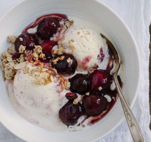 A bowl of ice cream with homemade cherry wine sauce on top.