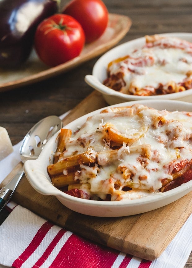 Portions of Baked Ziti with Roasted Eggplant and Peppers in white baking dishes.