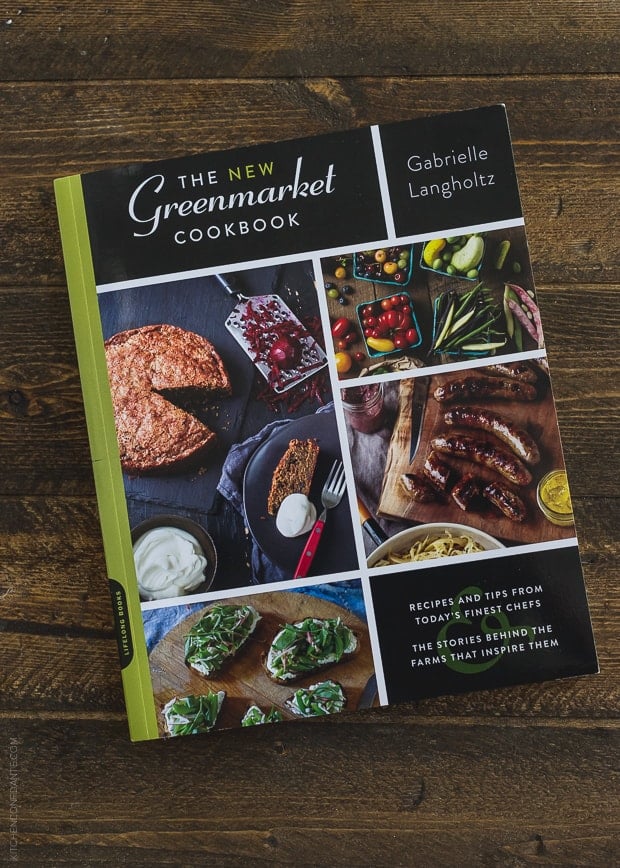 A cookbook, The New Greenmarket Cookbook, on a wooden surface.
