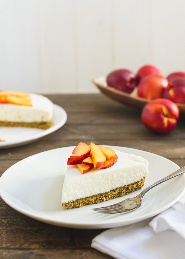 A slice of No-Bake Goat Cheese Cheesecake with Nectarine Compote on a white plate.