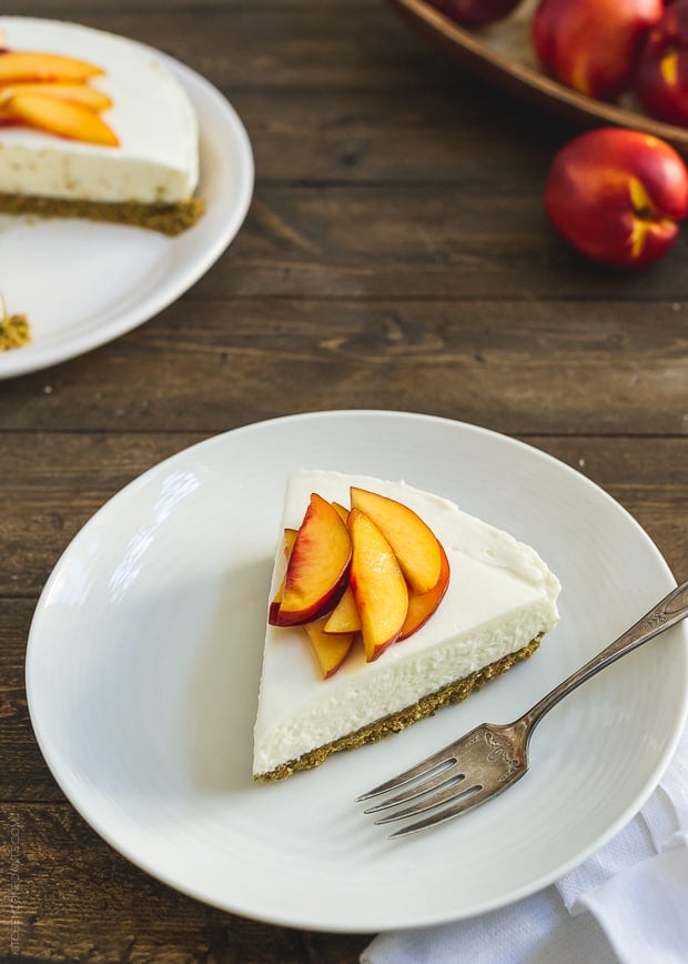 A slice of No-Bake Goat Cheese Cheesecake on a white plate with a fork.