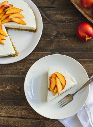 A slice of No-Bake Goat Cheese Cheesecake with Nectarine Compote on a white plate.