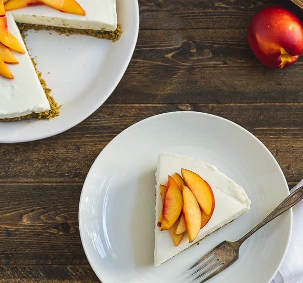 A slice of No-Bake Goat Cheese Cheesecake with Nectarine Compote on a white plate.