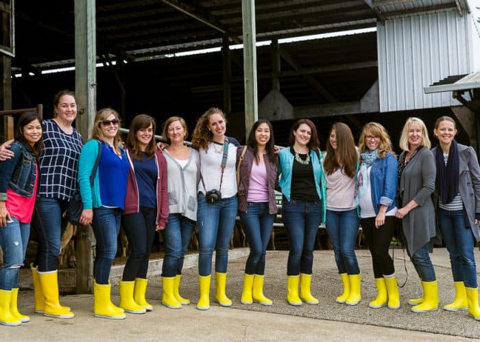 A group shot of the Bloggers in a row wearing yellow boots.