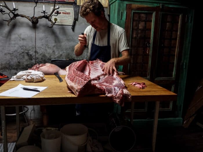 A man breaking down a hog at Advanced Butchery Class - Avedano's SF.