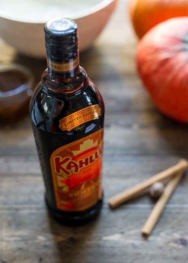 A bottle of Kahlúa Pumpkin Spice on a wooden surface.