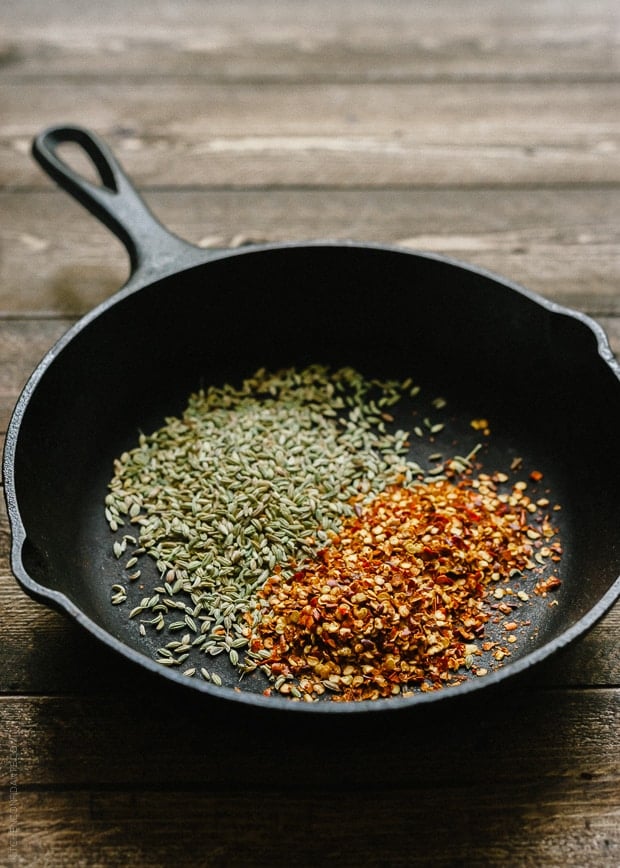 Toasting spices for Porchetta in a cast iron pan.