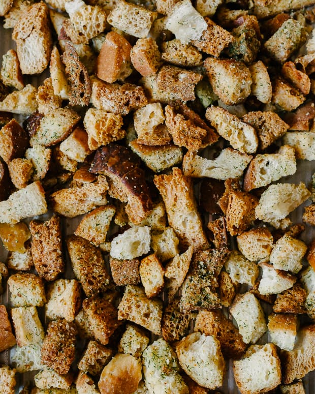 Homemade sourdough croutons on a baking sheet.