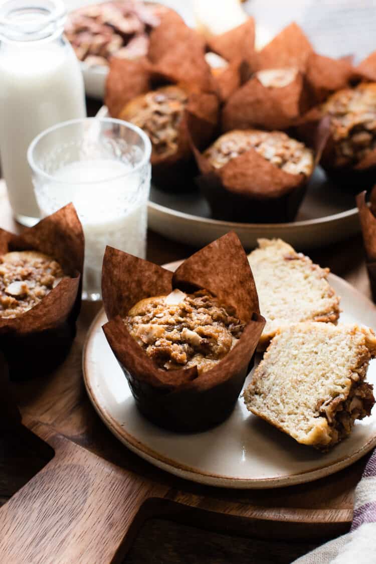 Banana Coconut Crunch Muffins on a wooden surface.
